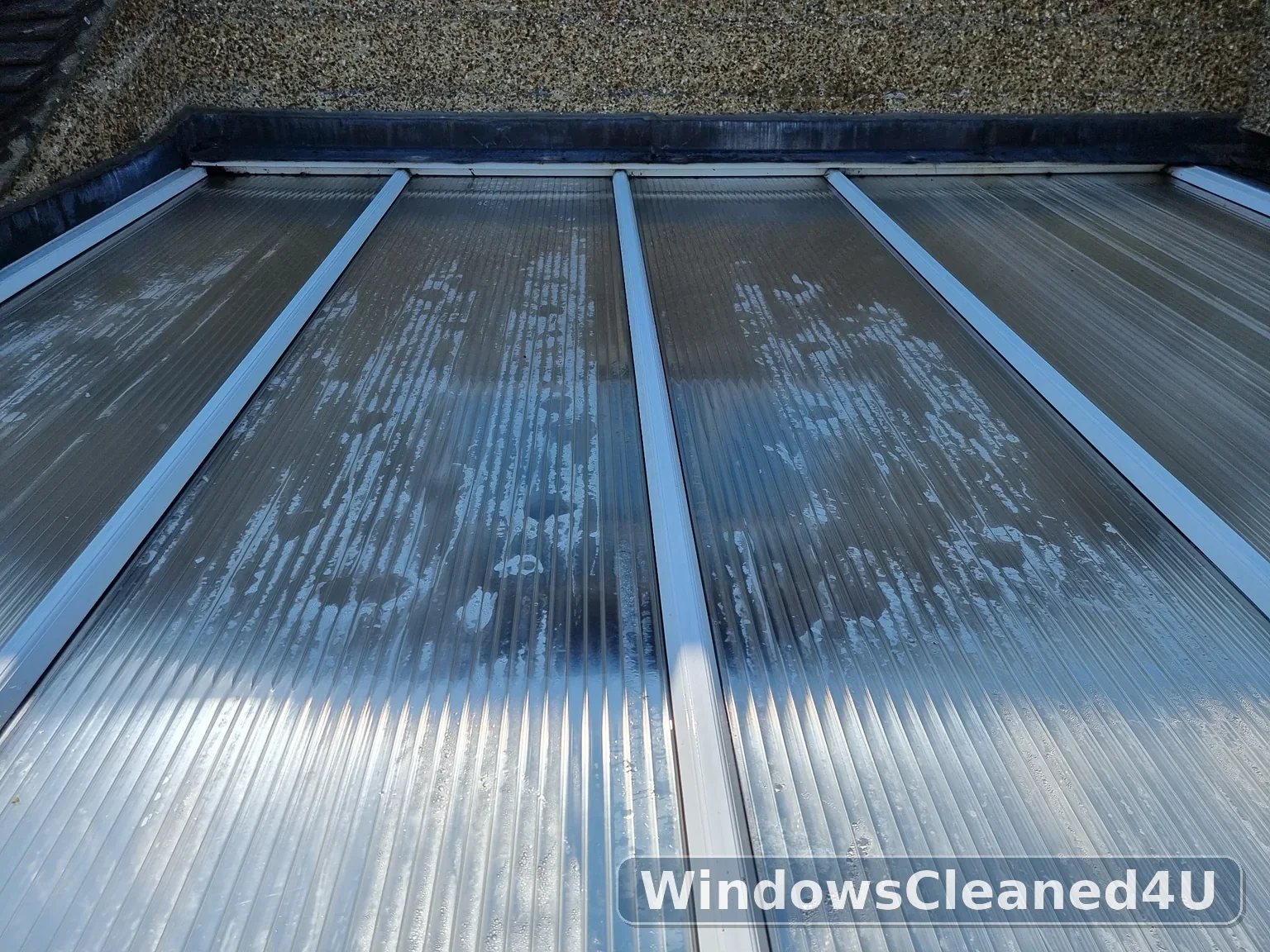 After cleaning: the same roof panels cleared of loose debris